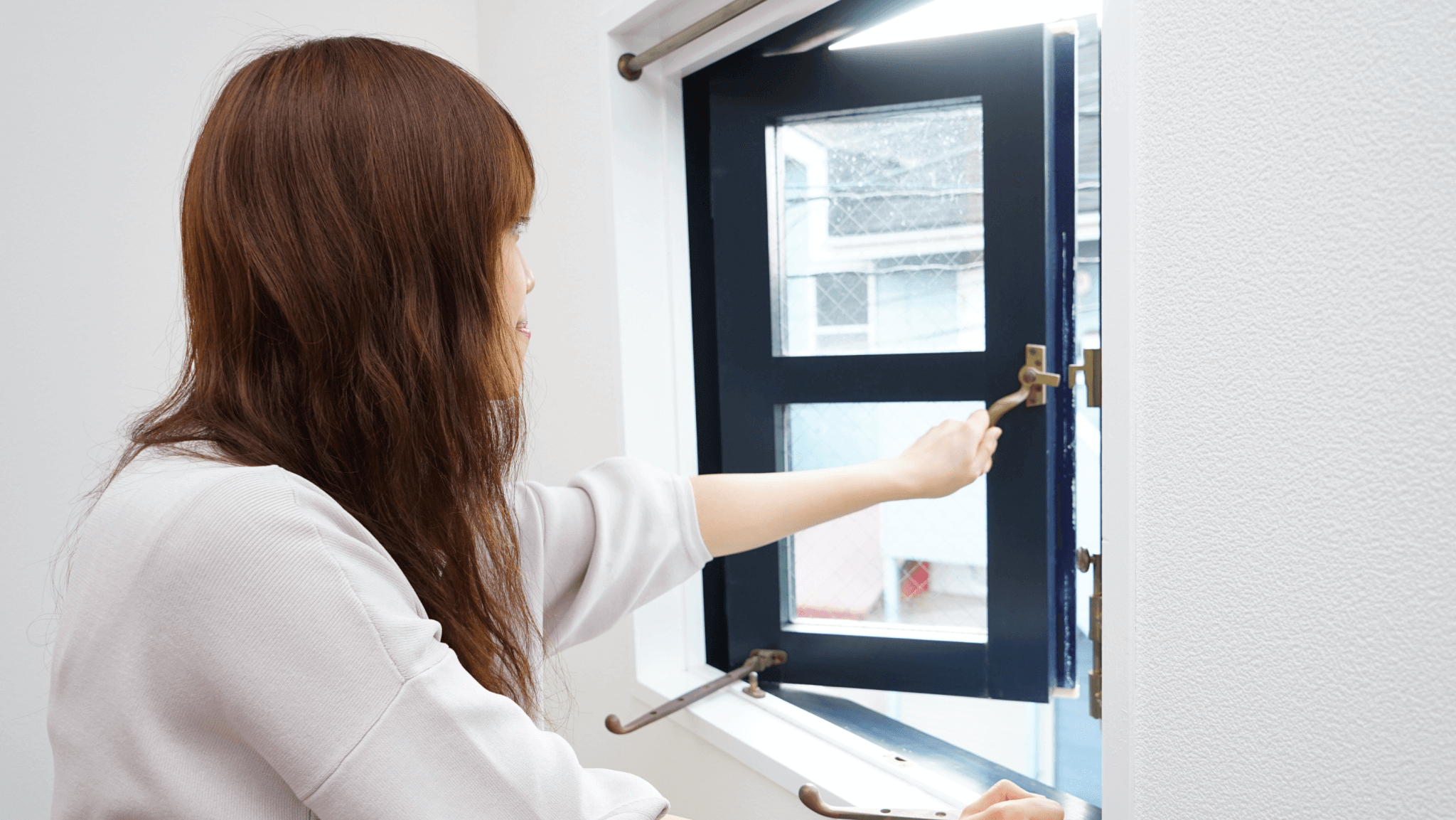 woman opening window